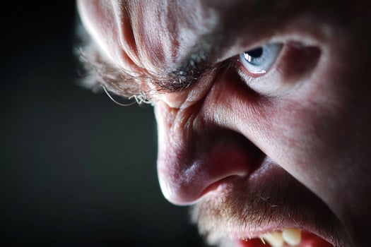 A close up of a man with his mouth open photo
