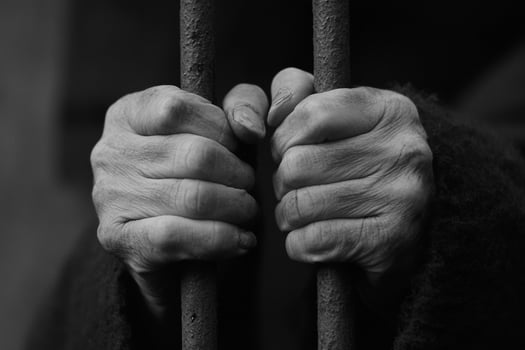 Hands of an old man in prison photo