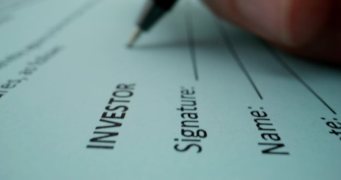 Investor signature on a document photo