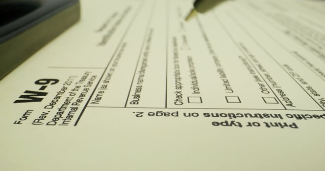 A tax form with a pen and a calculator photo