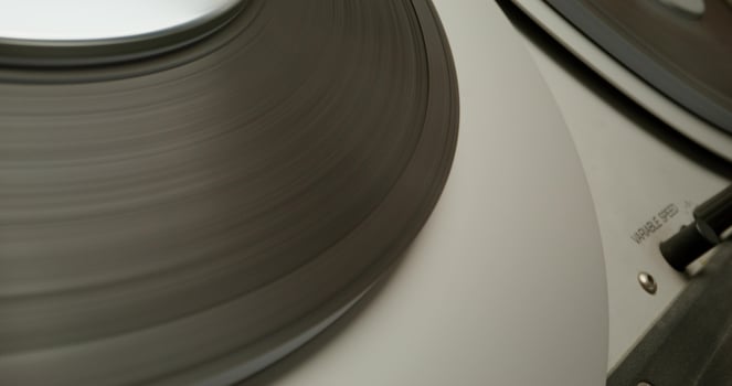 Sound recording on a tape recorder in a recording studio. Fast movement of the magnetic tape, close-up - magnetic - on photo