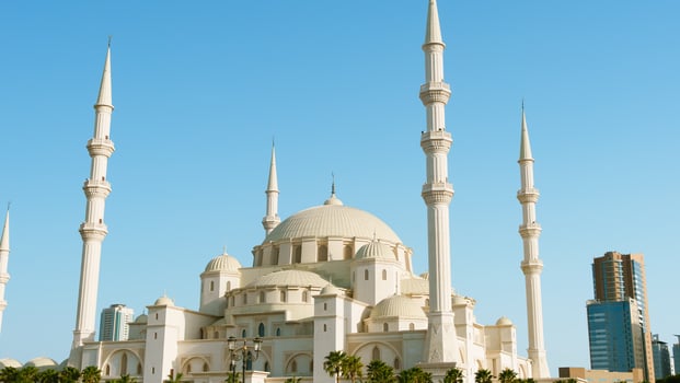 A large white mosque with tall white towers photo