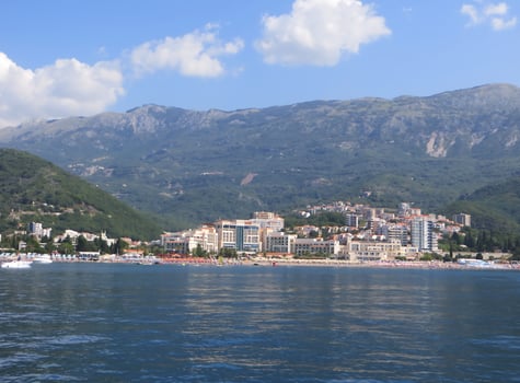 City. The picturesque city is spread out on the seashore. The sun's rays are reflected in the waves photo