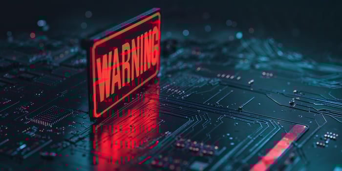 Glowing Red Warning Sign on Dark Circuit Board photo