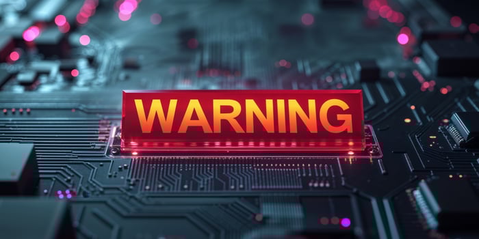 Glowing Red Warning Sign on Dark Circuit Board. photo