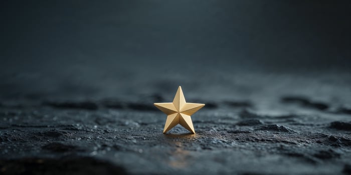 Glowing Gold Star on Dark Textured Surface photo