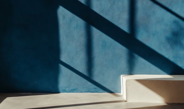 Empty room with textured wall and sunlight shadows photo