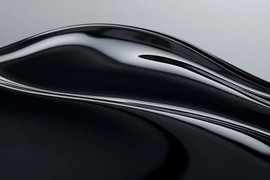 Sleek, dark, flowing abstract form with glossy, reflective surface photo