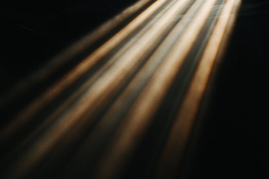Golden rays of light piercing darkness photo