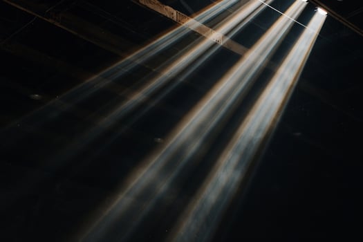 Light beams coming from the ceiling of a room photo