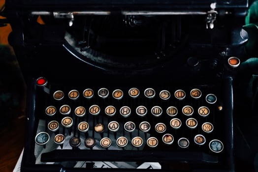 Vintage typewriter showcasing Cyrillic characters in a cozy workspace environment photo