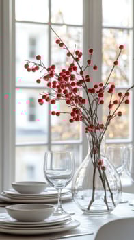 A table setting with red berries in a vase photo