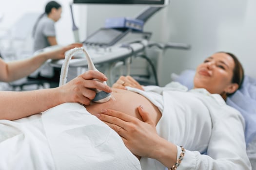 Pregnant ,woman is lying down in, the hospital, doctor does ultrasound photo
