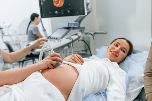 Pregnant, woman is, lying down in, the hospital, doctor does ultrasound photo