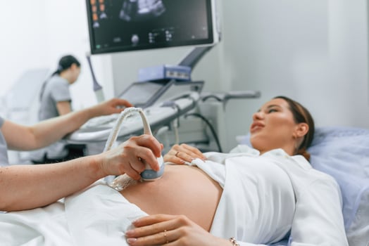 Close, up, view, scanning. Pregnant woman is lying down in the hospital, doctor does ultrasound photo