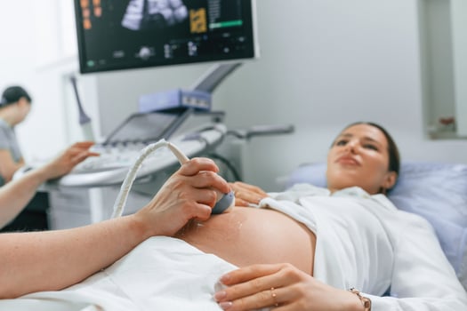 Close ,up view,, scanning. Pregnant woman is lying down in the hospital, doctor does ultrasound photo