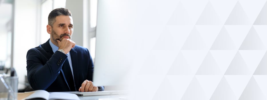 Middle aged businessman in a suit sits at his desk, deep in thought, contemplating decisions in a well-lit, modern office environment with ample copy space available, copy space photo