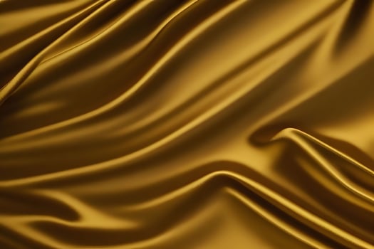 Golden silk drapery offers a luxurious texture that serves as an exquisite background, enhanced by its opulent hues. photo