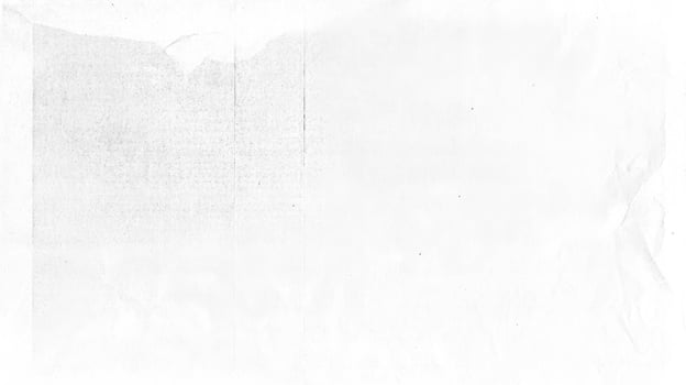 Vintage distressed texture of worn and crumpled old paper in black and white photo