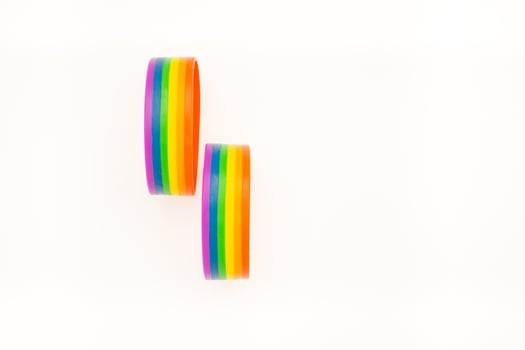 Close-up of two rainbow patterned wristbands are on a white background photo