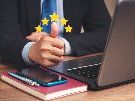 Close-up of businessman hand with thumb up for best excellent services satisfaction client giving a five-star rating photo