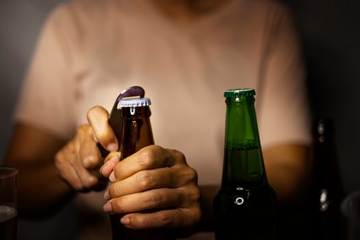 Hands Opening Beer Bottle On The Room Night photo