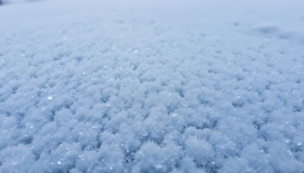 A close up of ice crystals forming on a frozen surface, showcasing their intricate patterns and frosty texture. photo
