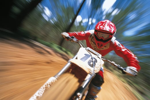 A person riding a dirt bike on a dirt road photo