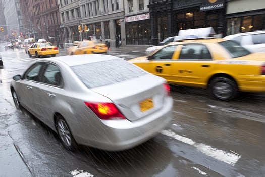 A car driving on a wet street photo
