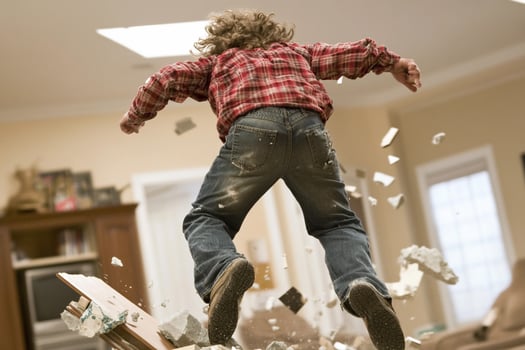 A young boy jumping into a pile of rubble photo