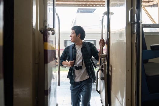 Entering the Train. A traveler steps inside the train, filled with excitement for the journey ahead. photo