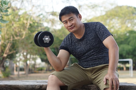 Handsome man exercises outdoor, lift dumbbell. Concept, Exercise for health bodybuilding. Strengthen muscle. Weight lifting. Healthy lifestyle. Sport equipment. Work out makes strong of body. photo