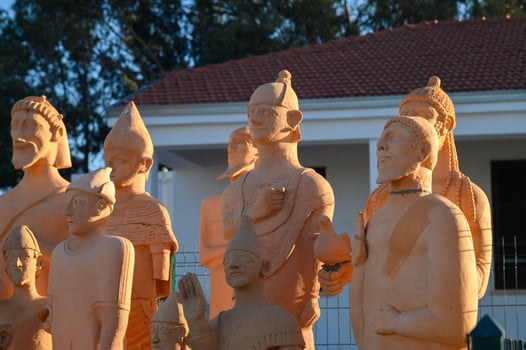 Intricate terracotta sculptures captured in warm afternoon light at an outdoor exhibition showcasing ancient artistry photo