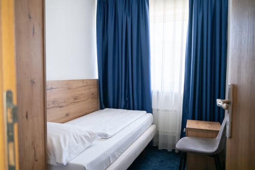 A modern and serene hotel room in a medical rehabilitation facility, designed for comfort and relaxation, offering a peaceful environment for patients to recover and rejuvenate photo