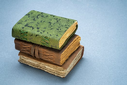 stack of retro journals with decked edge handmade paper pages, journaling concept photo