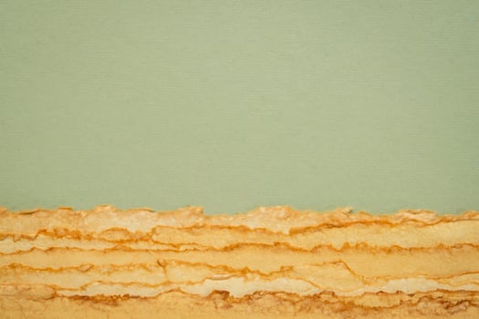 abstract desert landscape created with sheets of textured colorful handmade paper photo