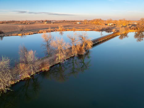 footbridge over Roulard Lake near Severance, Colorado in winter scenery - Great Western Bike Trail, rails to trails conversion project photo