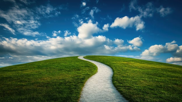 Serene pathway through rolling green hills under blue sky photo
