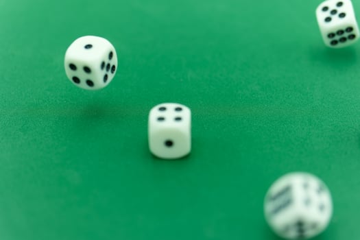 Rolling dice on a green felt surface creates excitement in a gam photo