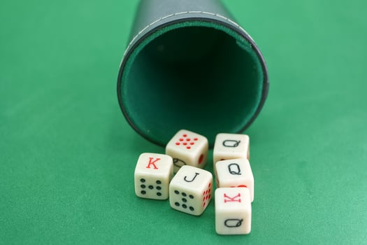 Dice roll reveals cards on a green felt photo