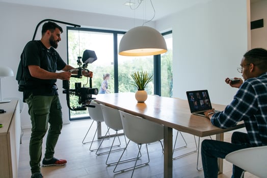 A cameraman talking with an African American man as they preparing to shoot a commercial . High quality photo