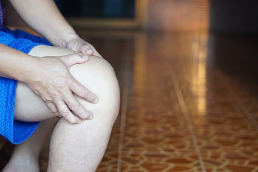 Close up man massages his knee, feel hurt. Concept, health problem. Leg injury or rheumatoid arthritis, gout. Injured knee joint. Trauma. Ache symptoms photo