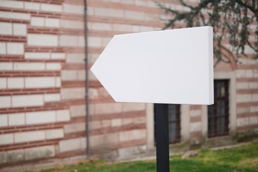 Blank directional sign outside historical building photo