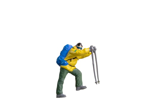 A Miniature Figurine of a Trekker with Hiking Poles isolated on white background with clipping path photo
