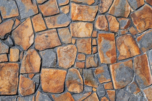 Fragment of a wall from a chipped stone. Wide panoramic stone pattern. photo