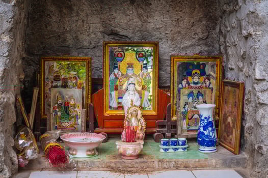 An altar with a Buddhist god outside a pagoda in Asia photo