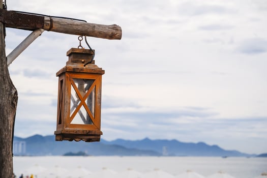Wooden retro vintage street lamp on background of cloudy sky during the day photo