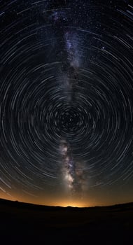 Magnificent star trails create a mesmerizing spiral around the night sky's center point. photo