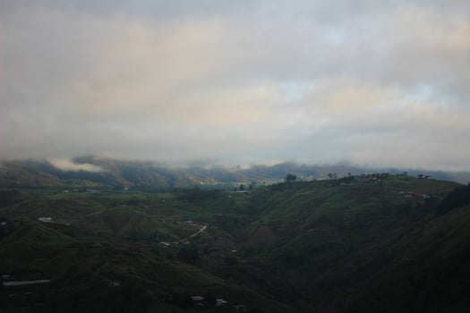 Picturesque Mountain Landscape with Mist-Covered Hills and Vibrant Greenery photo