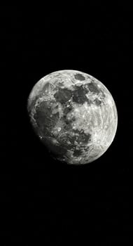 A detailed view of the moon, showcasing its craters and textures against the starlit night. photo